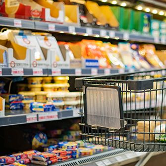 a shoping car in the dairy aisle 