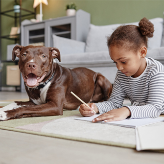 Girl laying on floor next to dog