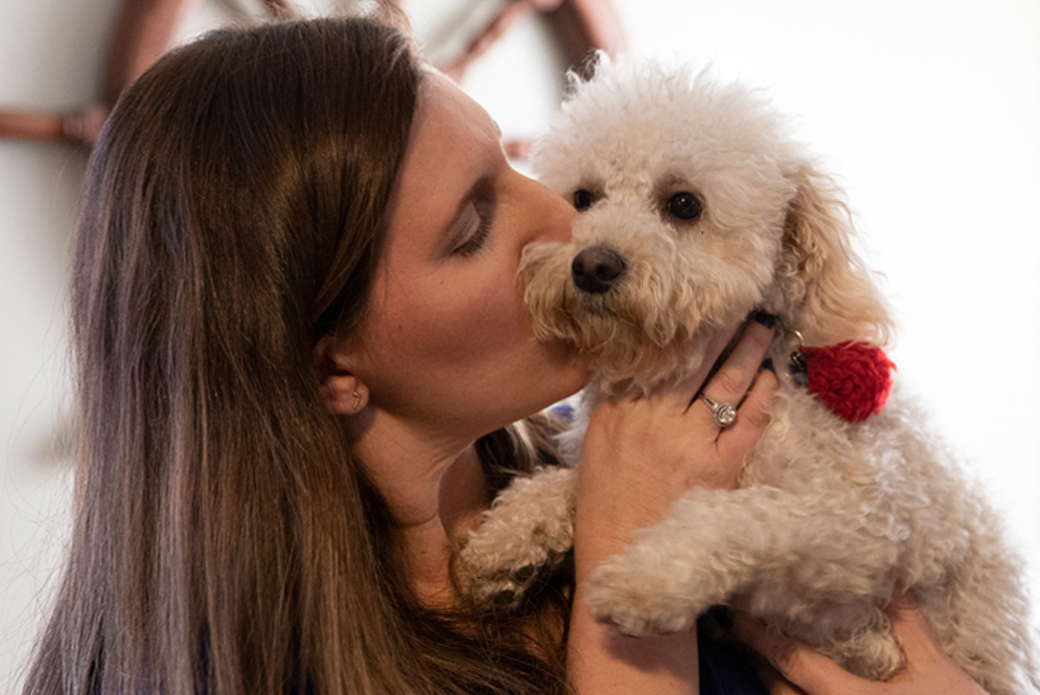 Woman kissing dog