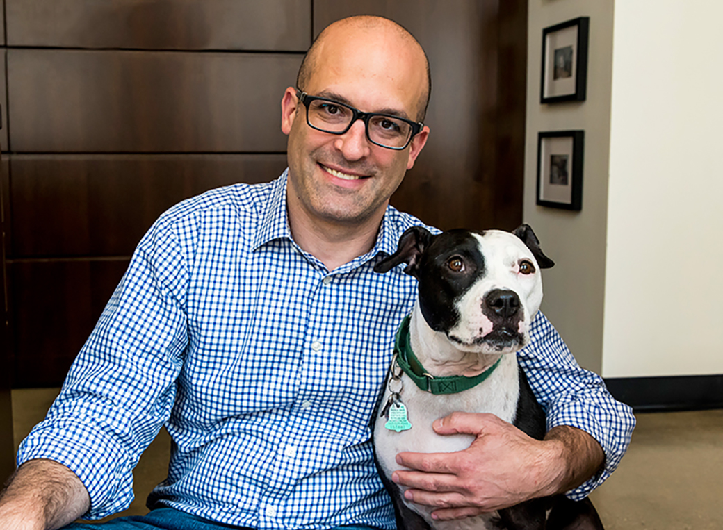 Matt Bershadker with a black and white pitbull